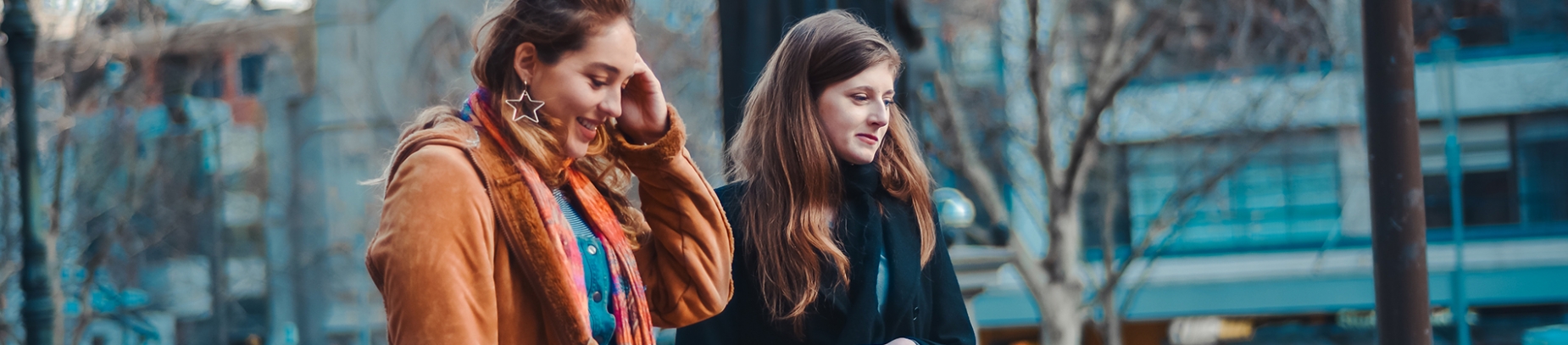 Two girls walking down the road chatting