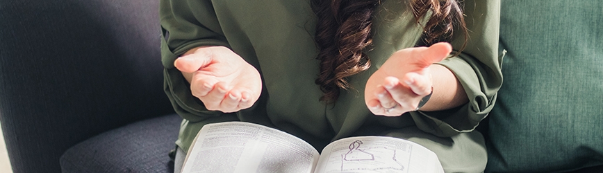 Women with her hands out in prayer